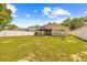 Spacious backyard with gazebo, lush lawn, and white fence, perfect for outdoor enjoyment at 635 Painted Leaf Dr, Brooksville, FL 34604