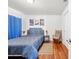 Cozy bedroom with blue bedding, wood floors, and modern art prints, creating a relaxing atmosphere at 635 Painted Leaf Dr, Brooksville, FL 34604