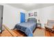 Inviting bedroom with stylish blue bedding, wood flooring, and elegant wall decor at 635 Painted Leaf Dr, Brooksville, FL 34604