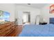 Comfortable bedroom with hardwood floors, soft natural light, and easy access to the ensuite bathroom at 635 Painted Leaf Dr, Brooksville, FL 34604