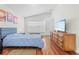 Bright bedroom featuring a ceiling fan, window, wood floors and ample space to relax and unwind at 635 Painted Leaf Dr, Brooksville, FL 34604
