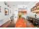 Bright dining room featuring an elegant chandelier, a view of the kitchen, and decoratively adorned white walls at 635 Painted Leaf Dr, Brooksville, FL 34604