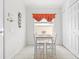 Bright breakfast nook featuring a white table set, window with valance, and convenient access to storage closet at 635 Painted Leaf Dr, Brooksville, FL 34604