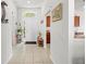 Bright entryway featuring tile flooring, white door, and a decorative plant with natural light streaming in at 635 Painted Leaf Dr, Brooksville, FL 34604