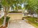 Well-maintained single-Gathering home with a manicured lawn, two-car garage, and inviting front entrance at 635 Painted Leaf Dr, Brooksville, FL 34604