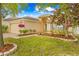 Attractive single-story home with manicured landscaping and a welcoming entrance under a bright blue sky at 635 Painted Leaf Dr, Brooksville, FL 34604