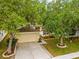 Charming single-Gathering home featuring a well-maintained lawn, mature trees, and a two-car garage at 635 Painted Leaf Dr, Brooksville, FL 34604