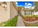 Inviting home exterior with a well-kept lawn, tidy landscaping, and a charming front entrance with number 635 at 635 Painted Leaf Dr, Brooksville, FL 34604