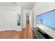 Hallway with wood floors and a doorway view of a blue bedroom at 635 Painted Leaf Dr, Brooksville, FL 34604