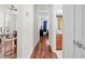 Hallway with hardwood floors and a view of multiple rooms in the home at 635 Painted Leaf Dr, Brooksville, FL 34604