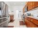 Spacious kitchen boasts stainless steel appliances, ample cabinet space, and tile flooring flowing into adjacent rooms at 635 Painted Leaf Dr, Brooksville, FL 34604