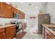 Functional kitchen boasts wood cabinets, stainless steel appliances, and a cozy breakfast nook with natural lighting at 635 Painted Leaf Dr, Brooksville, FL 34604