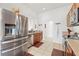 Bright kitchen with stainless steel refrigerator, dishwasher, and appliances, complemented by warm wood cabinetry at 635 Painted Leaf Dr, Brooksville, FL 34604