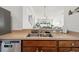 Well-lit kitchen featuring a stainless steel sink, updated appliances, and seamless flow to the open-concept living area at 635 Painted Leaf Dr, Brooksville, FL 34604