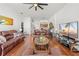 Open living space with a dining area, leather sofas, a ceiling fan, and natural light throughout at 635 Painted Leaf Dr, Brooksville, FL 34604