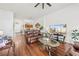 Bright living room featuring hardwood floors, comfortable leather sofas, and a large flat-screen television at 635 Painted Leaf Dr, Brooksville, FL 34604
