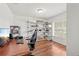 Home office featuring wood floors, a desk, an office chair, and shelving at 635 Painted Leaf Dr, Brooksville, FL 34604