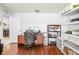 Functional home office with a desk, shelves for storage, and wood-look floors at 635 Painted Leaf Dr, Brooksville, FL 34604