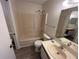 Compact bathroom featuring tub and shower, with a single sink vanity at 6440 Spring Flower Dr # 14, New Port Richey, FL 34653
