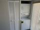 Convenient laundry closet with stacked washer and dryer units, adjacent to storage at 6440 Spring Flower Dr # 14, New Port Richey, FL 34653