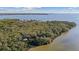 Beautiful waterfront acreage featuring mature trees and a serene setting on a natural shoreline at 6691 Wander Ln, New Port Richey, FL 34652
