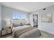 Bright bedroom features a large window, plush bed with neutral tones, and is steps from the kitchen at 6691 Wander Ln, New Port Richey, FL 34652