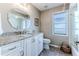Bathroom featuring a granite countertop, vanity with white cabinets, and natural light at 7129 Myrtlewood Ln, Spring Hill, FL 34606