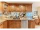 Functional kitchen with granite countertops, a stainless steel dishwasher, and wooden cabinetry at 7129 Myrtlewood Ln, Spring Hill, FL 34606