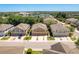 Aerial view of homes with multiple car garages and long driveways nestled amongst lush greenery at 7500 Red Mill Cir, New Port Richey, FL 34653