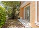 Home exterior with sliding glass doors leading to backyard and lush greenery at 7500 Red Mill Cir, New Port Richey, FL 34653