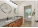 Bathroom with double vanity, granite countertop, and natural light from the window at 7500 Red Mill Cir, New Port Richey, FL 34653