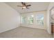 Bedroom featuring vaulted ceiling, ceiling fan, carpet and bright windows at 7500 Red Mill Cir, New Port Richey, FL 34653