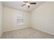 Bedroom featuring carpeted floors, ceiling fan, and large window with natural light at 7500 Red Mill Cir, New Port Richey, FL 34653