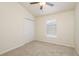 Bedroom with vaulted ceiling, carpet, closet, and large window with natural light at 7500 Red Mill Cir, New Port Richey, FL 34653