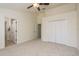 Spacious bedroom features neutral carpet, ceiling fan, and large closet for ample storage at 7500 Red Mill Cir, New Port Richey, FL 34653