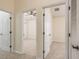 Hallway offers views into carpeted bedrooms with ceiling fans and large closets at 7500 Red Mill Cir, New Port Richey, FL 34653