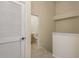 Hallway leading to a bathroom with modern fixtures and a neutral color scheme at 7500 Red Mill Cir, New Port Richey, FL 34653