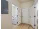 Hallway view to in-unit laundry closet, door to garage, and powder room at 7500 Red Mill Cir, New Port Richey, FL 34653
