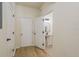 Hallway featuring wood-look flooring, access to the powder room and extra storage space at 7500 Red Mill Cir, New Port Richey, FL 34653