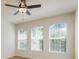 Bright living room with ceiling fan and many windows at 7500 Red Mill Cir, New Port Richey, FL 34653