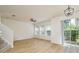 Bright living room featuring wood floors, fan, recessed lighting, and sliding glass door at 7500 Red Mill Cir, New Port Richey, FL 34653