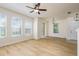 Spacious living room boasts wood floors, multiple windows, and modern lighting at 7500 Red Mill Cir, New Port Richey, FL 34653