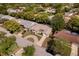 Bird's eye view of a charming home with a circular driveway, lush trees, and well-manicured lawn at 8505 Lincolnshire Dr, Hudson, FL 34667
