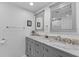 Bathroom featuring double sinks with marble countertops and updated fixtures at 8505 Lincolnshire Dr, Hudson, FL 34667