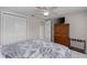 Cozy bedroom with ceiling fan, closet, and TV on a wooden dresser at 8505 Lincolnshire Dr, Hudson, FL 34667