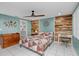 Bedroom featuring aqua-colored walls and a natural wood accent wall with a ceiling fan at 8505 Lincolnshire Dr, Hudson, FL 34667