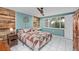 Bedroom featuring aqua-colored walls and a natural wood accent wall with a view at 8505 Lincolnshire Dr, Hudson, FL 34667