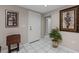 Bright home entryway with neutral walls, tile floors, and decorative art at 8505 Lincolnshire Dr, Hudson, FL 34667