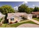Charming one-story home with a brick facade, well-maintained lawn, and a curved driveway at 8505 Lincolnshire Dr, Hudson, FL 34667