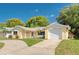 Charming one-story home with a brick facade, well-maintained lawn, and a curved driveway at 8505 Lincolnshire Dr, Hudson, FL 34667